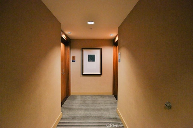 hallway featuring baseboards, carpet flooring, and recessed lighting