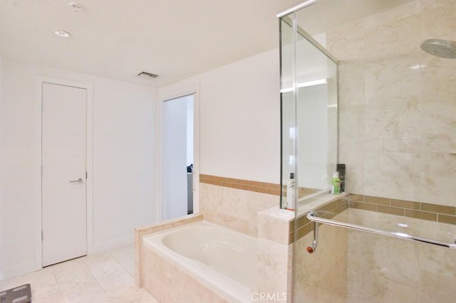 bathroom with visible vents, a bath, and a stall shower