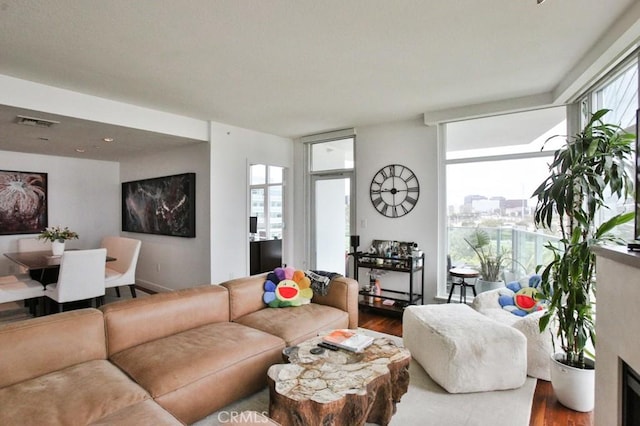 living room with dark wood-style flooring and visible vents