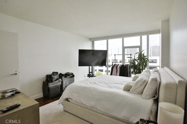 bedroom with baseboards and dark wood-style floors
