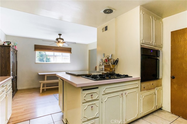 kitchen featuring light countertops, oven, visible vents, and gas cooktop