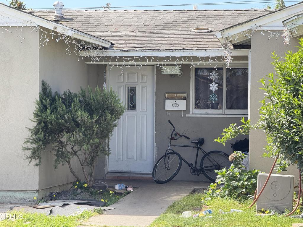 1438 W Guava St, Oxnard, CA 93033 - property entrance with roof with shingles and stucco siding