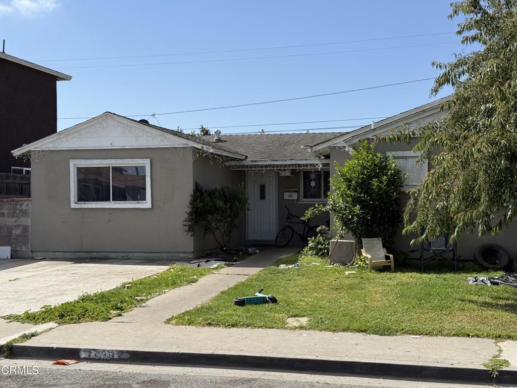1438 W Guava St, Oxnard, CA 93033 - view of front of property featuring a front lawn, stucco siding, and roof with shingles