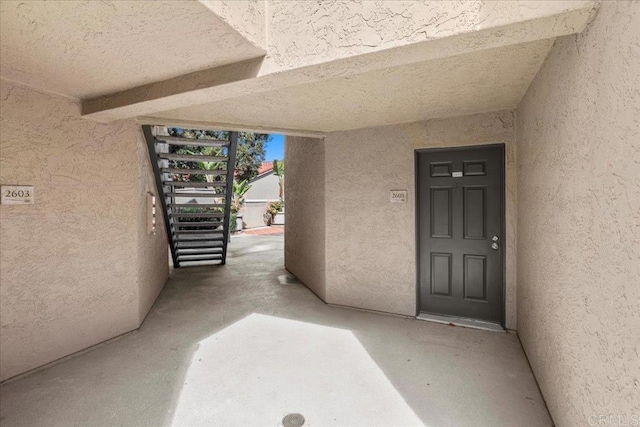 entrance to property featuring stucco siding