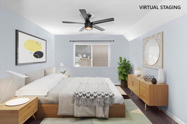 bedroom with baseboards, vaulted ceiling, ceiling fan, and wood finished floors