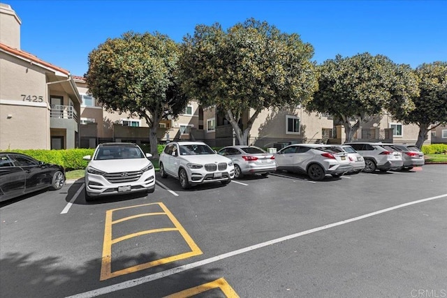 uncovered parking lot with a residential view