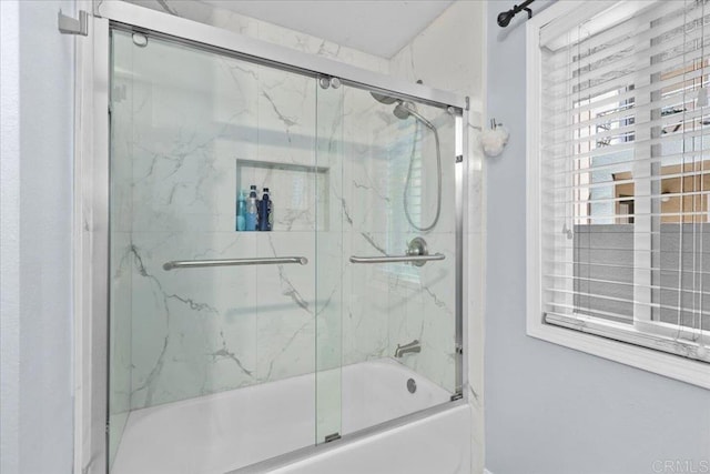 bathroom featuring bath / shower combo with glass door