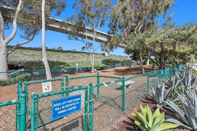 view of home's community featuring fence