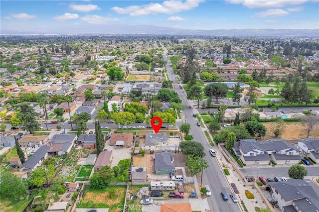 drone / aerial view featuring a residential view and a mountain view