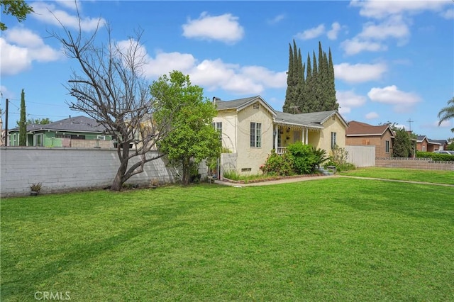 ranch-style house featuring fence, a residential view, a front yard, and stucco siding