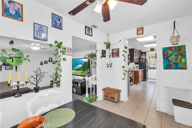 dining area featuring ceiling fan, visible vents, and light tile patterned floors