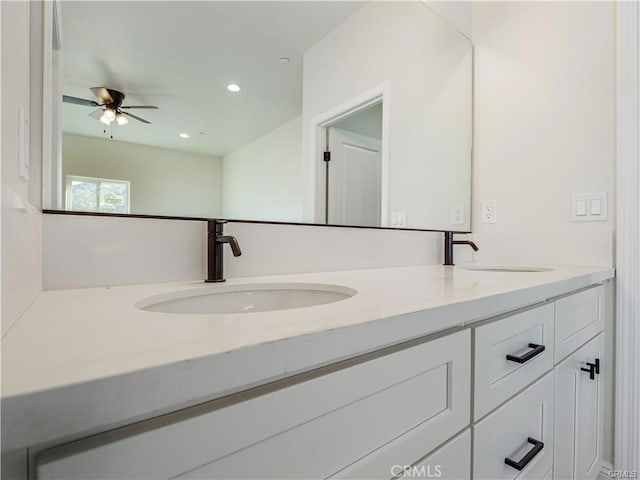 full bath with a sink, ceiling fan, recessed lighting, and double vanity