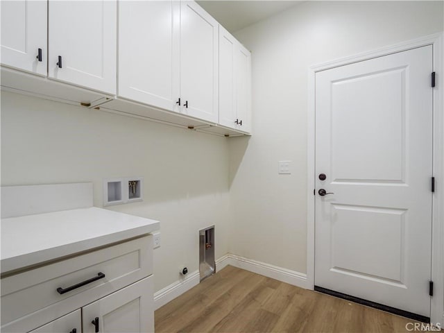 clothes washing area featuring cabinet space, washer hookup, light wood-style flooring, baseboards, and electric dryer hookup