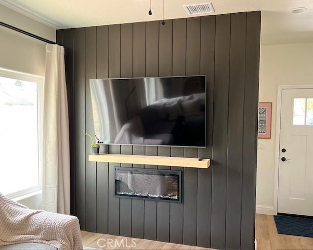 room details featuring visible vents and wood finished floors