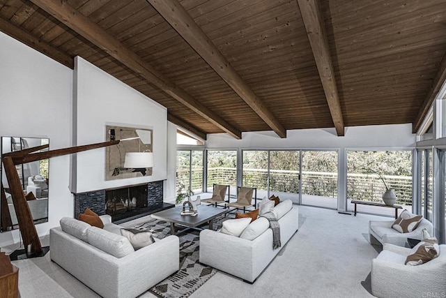 carpeted living area with wooden ceiling, vaulted ceiling with beams, and a healthy amount of sunlight
