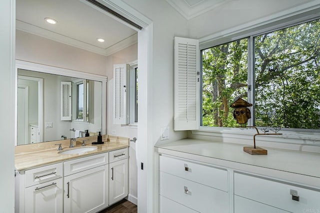 bathroom with recessed lighting, ornamental molding, and vanity