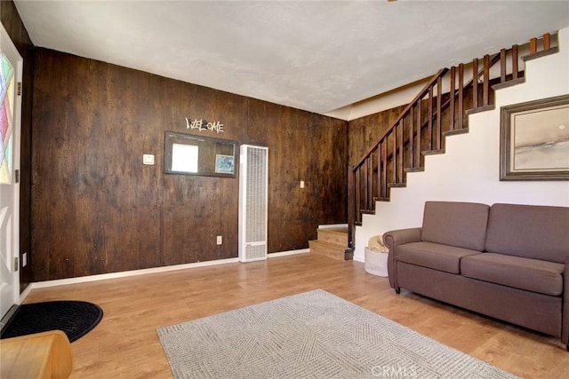 133 Holmes Ln, Sugarloaf, CA 92386 - living area with baseboards, wood walls, stairs, and wood finished floors