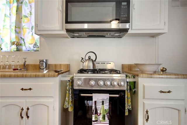 133 Holmes Ln, Sugarloaf, CA 92386 - kitchen with white cabinets, light countertops, and range with gas cooktop
