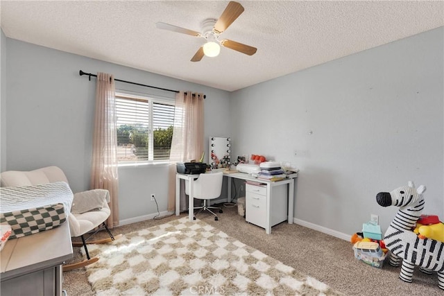 office featuring baseboards, a ceiling fan, a textured ceiling, and carpet floors