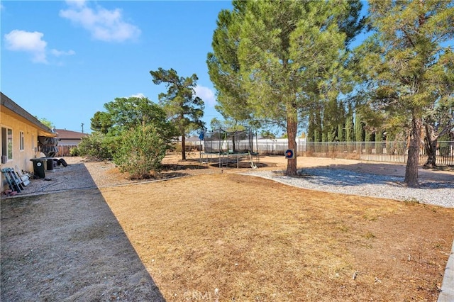 view of yard with a fenced backyard and a trampoline