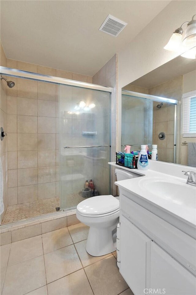 12546 Snapping Turtle Rd, Apple Valley, CA 92308 - full bathroom with vanity, toilet, a stall shower, and tile patterned flooring