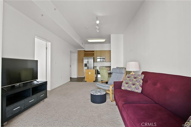 living room featuring light colored carpet and baseboards