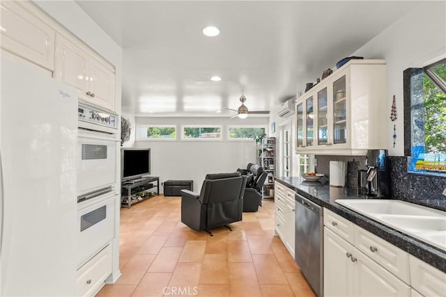 kitchen featuring glass insert cabinets, dishwasher, white cabinets, and white double oven