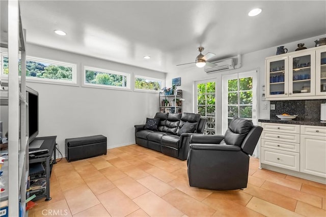 living area featuring light tile patterned floors, ceiling fan, a wall unit AC, and recessed lighting