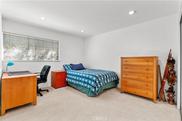 bedroom featuring light carpet and recessed lighting