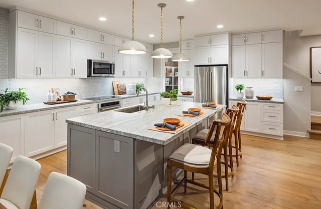 8638 Mission Villa Dr, Rosemead, CA 91770 - kitchen featuring stainless steel appliances, recessed lighting, a kitchen breakfast bar, and a sink