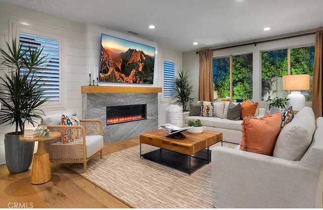8638 Mission Villa Dr, Rosemead, CA 91770 - living area featuring recessed lighting, a glass covered fireplace, wood finished floors, and visible vents