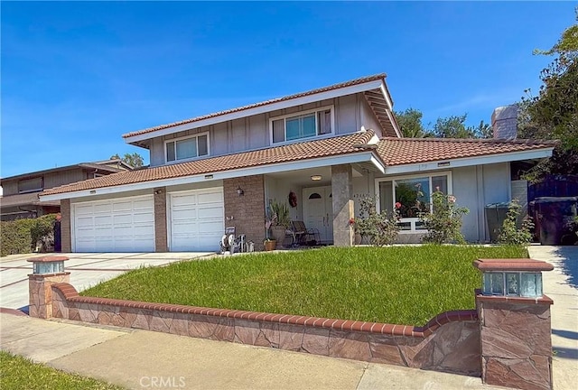 view of front of house featuring a tiled roof, a garage, a front lawn, concrete driveway, and stucco siding