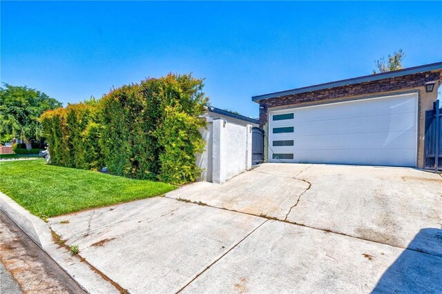 exterior space with a yard and a detached garage