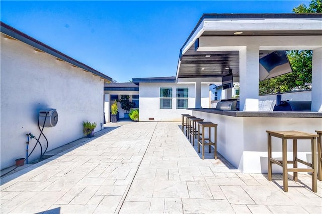 view of patio with outdoor wet bar