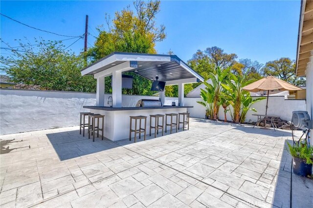 view of patio / terrace with outdoor dry bar, a gazebo, and fence private yard