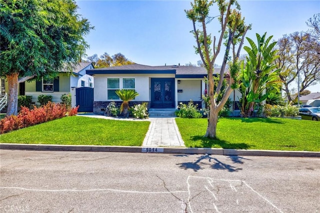 single story home with french doors, stucco siding, and a front yard