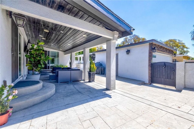 view of patio with an outdoor living space, a gate, and fence