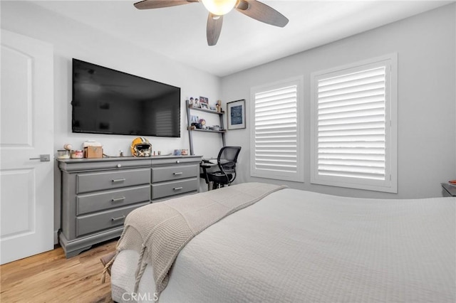bedroom with light wood-style flooring and ceiling fan