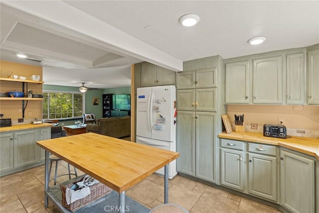 1489 Manzanita Ave, Chico, CA 95926 - kitchen featuring freestanding refrigerator, wooden counters, green cabinetry, and ceiling fan