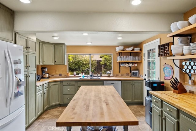 1489 Manzanita Ave, Chico, CA 95926 - kitchen featuring wooden counters, freestanding refrigerator, green cabinetry, a sink, and open shelves