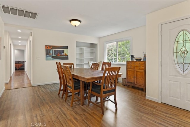 1489 Manzanita Ave, Chico, CA 95926 - dining area featuring wood finished floors, built in shelves, baseboards, and recessed lighting