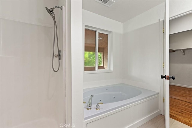 1489 Manzanita Ave, Chico, CA 95926 - bathroom with a walk in shower, wood finished floors, and a jetted tub
