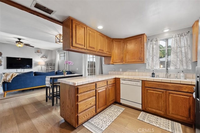 3241 Mills Ln, Crescenta, CA 91214 - kitchen with white dishwasher, light wood-style floors, ceiling fan, brown cabinetry, and recessed lighting