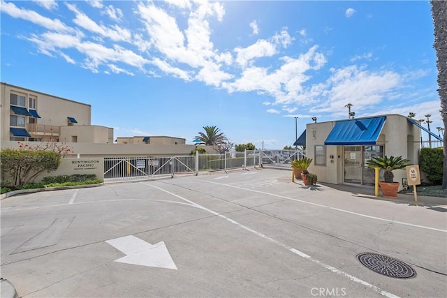 711 Pacific Coast Unit 325, Huntington Beach, CA 92648 - view of street featuring a gate, a gated entry, and curbs