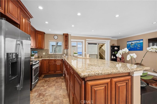 711 Pacific Coast Unit 325, Huntington Beach, CA 92648 - kitchen featuring decorative backsplash, appliances with stainless steel finishes, light stone countertops, brown cabinets, and a peninsula