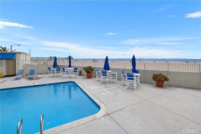 711 Pacific Coast Unit 325, Huntington Beach, CA 92648 - pool with a water view, fence, and a patio area