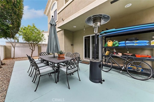 view of patio featuring fence and outdoor dining space