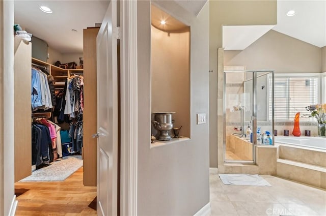 full bath featuring a garden tub, recessed lighting, a spacious closet, and a shower stall