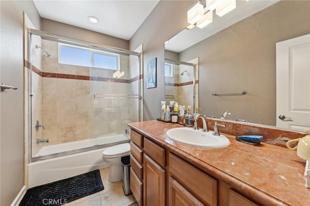 full bath with vanity, enclosed tub / shower combo, tile patterned flooring, and toilet