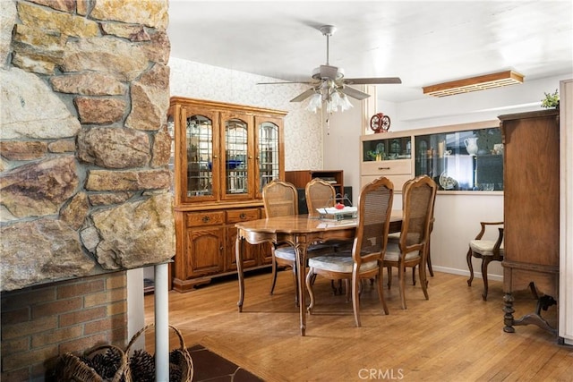 dining room with a ceiling fan and light wood-type flooring